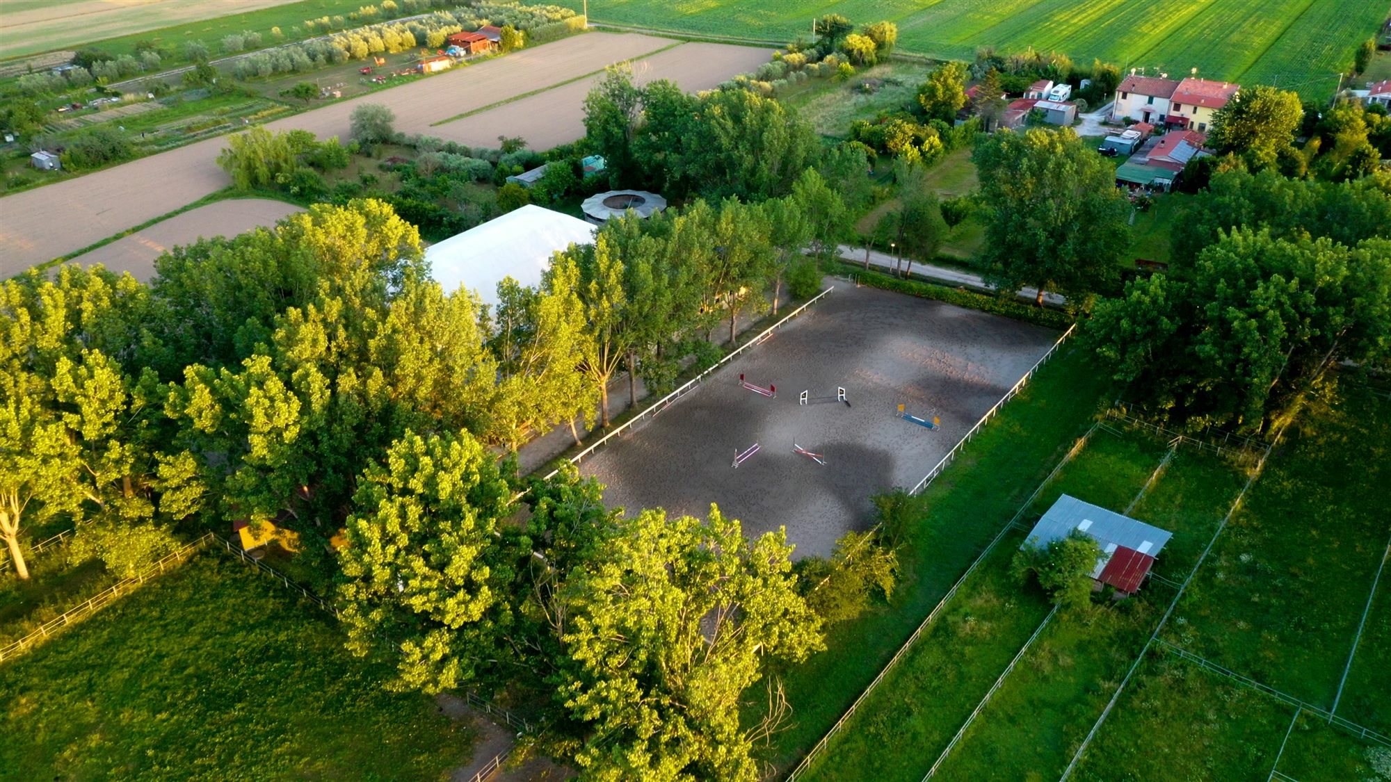 View across the arenas and horse walker